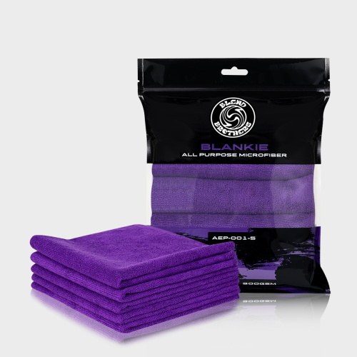 Profesjonalny packshot zestawu 5 fioletowych mikrofibr Blankie z opakowaniem zbiorczym na jasnoszarym tle.