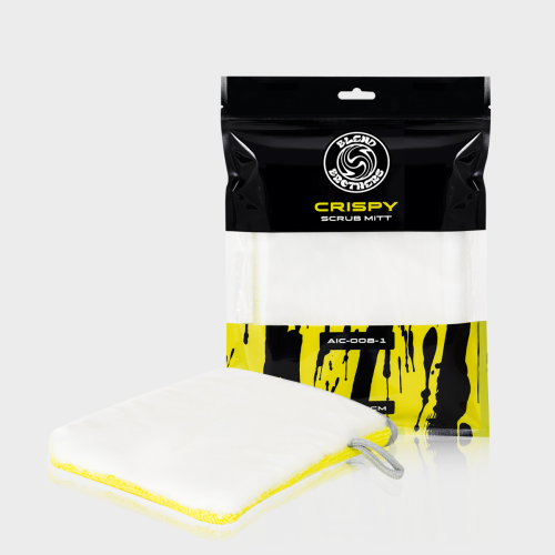 Dwustronna rękawica czyszcząca Crispy Scrub Mitt obok opakowania na limonkowym tle.