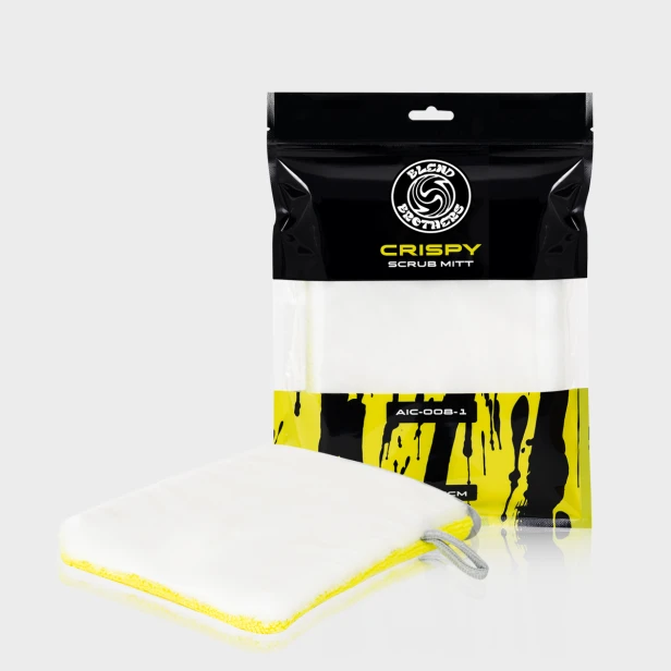 Dwustronna rękawica czyszcząca Crispy Scrub Mitt obok opakowania na limonkowym tle.